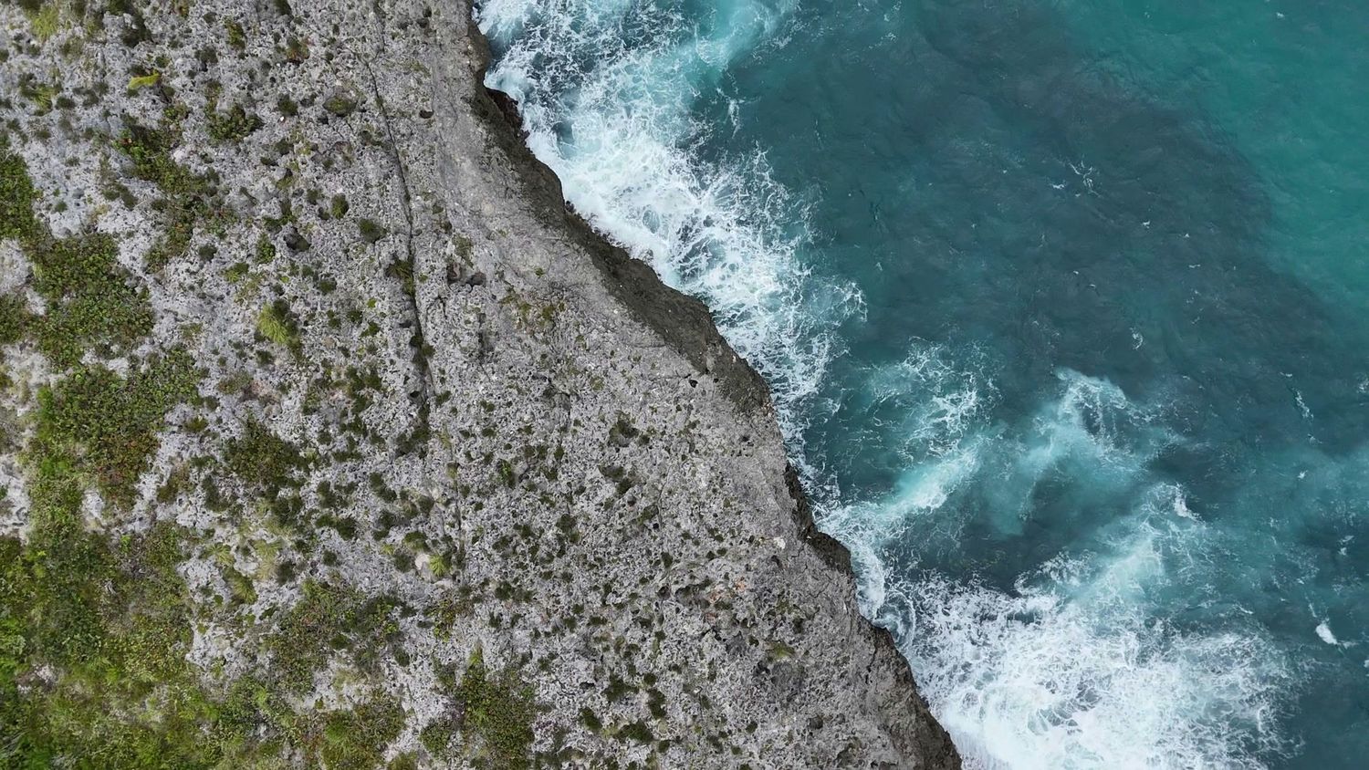 Surf breaking on the cliffs below the Taína land